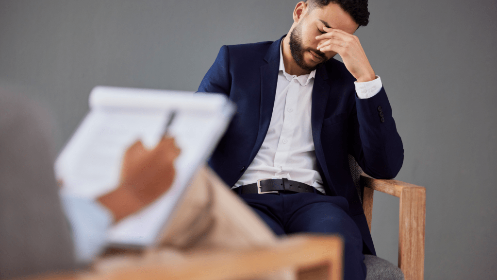 Man in therapy pondering the damage debt does to his relationships