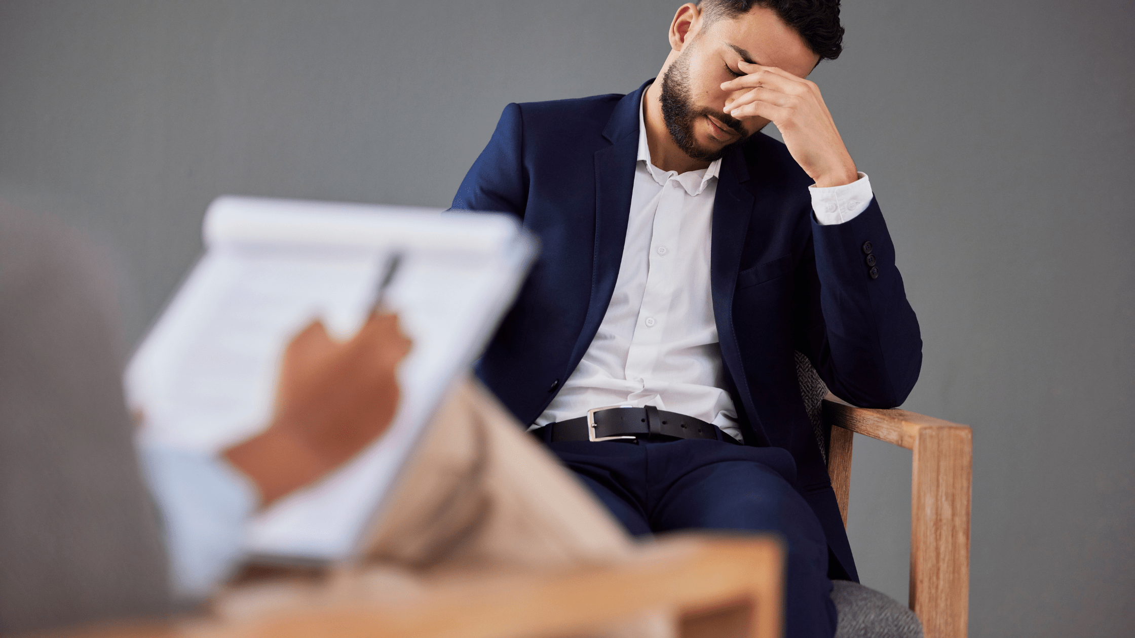Man in therapy pondering the damage debt does to his relationships