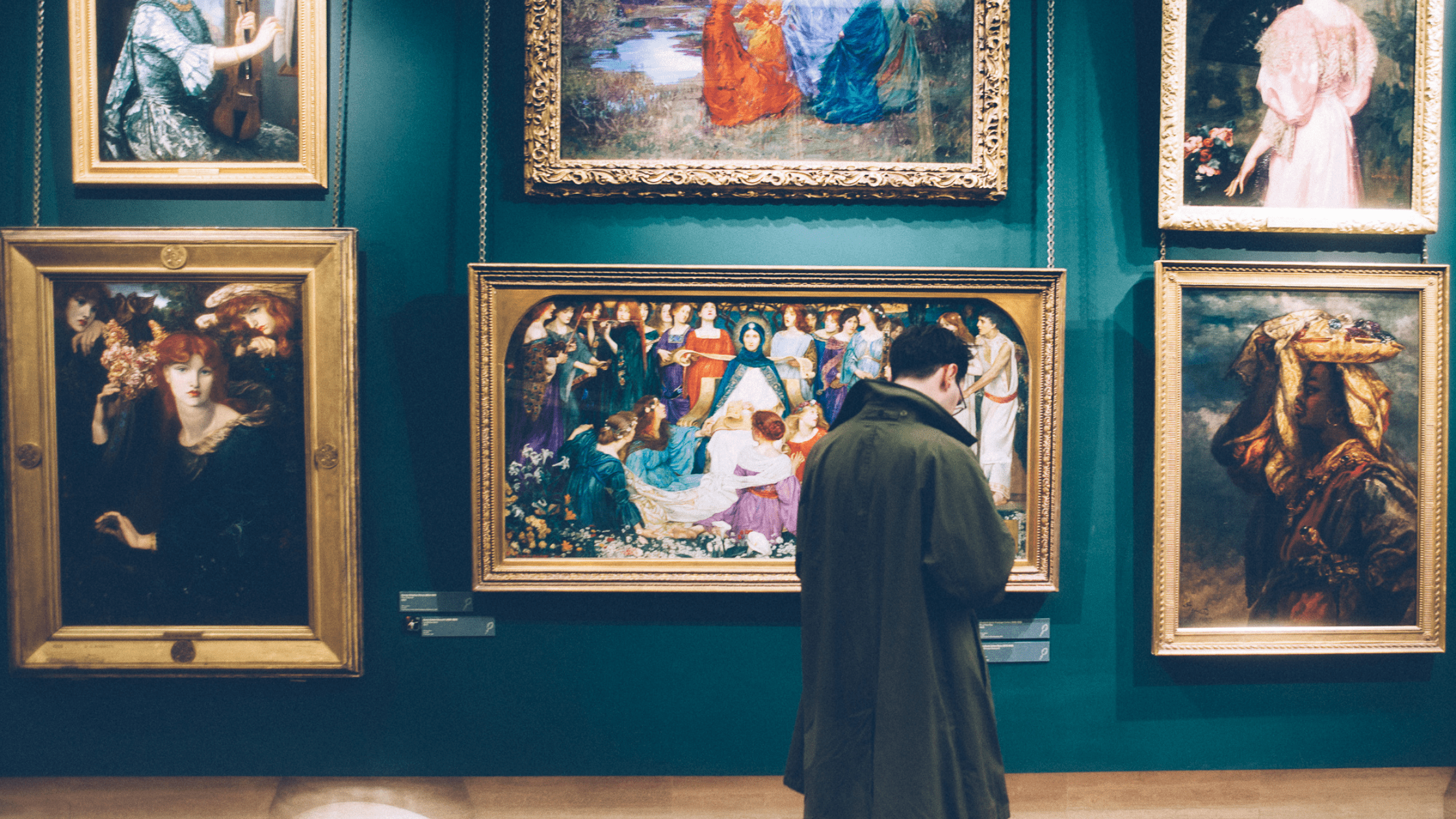 Man looking at artwork to buy