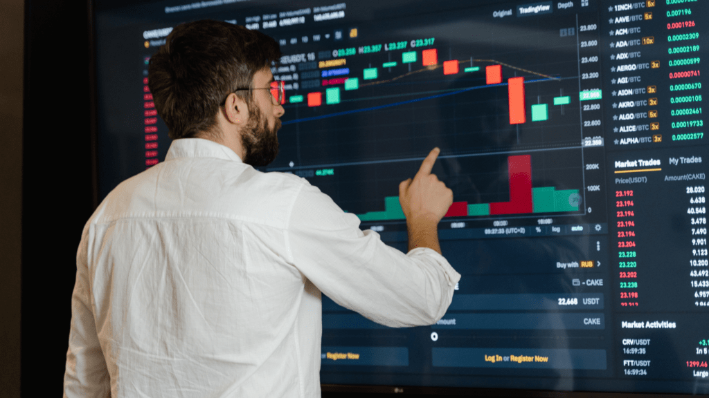 Man looking at a screen with investments